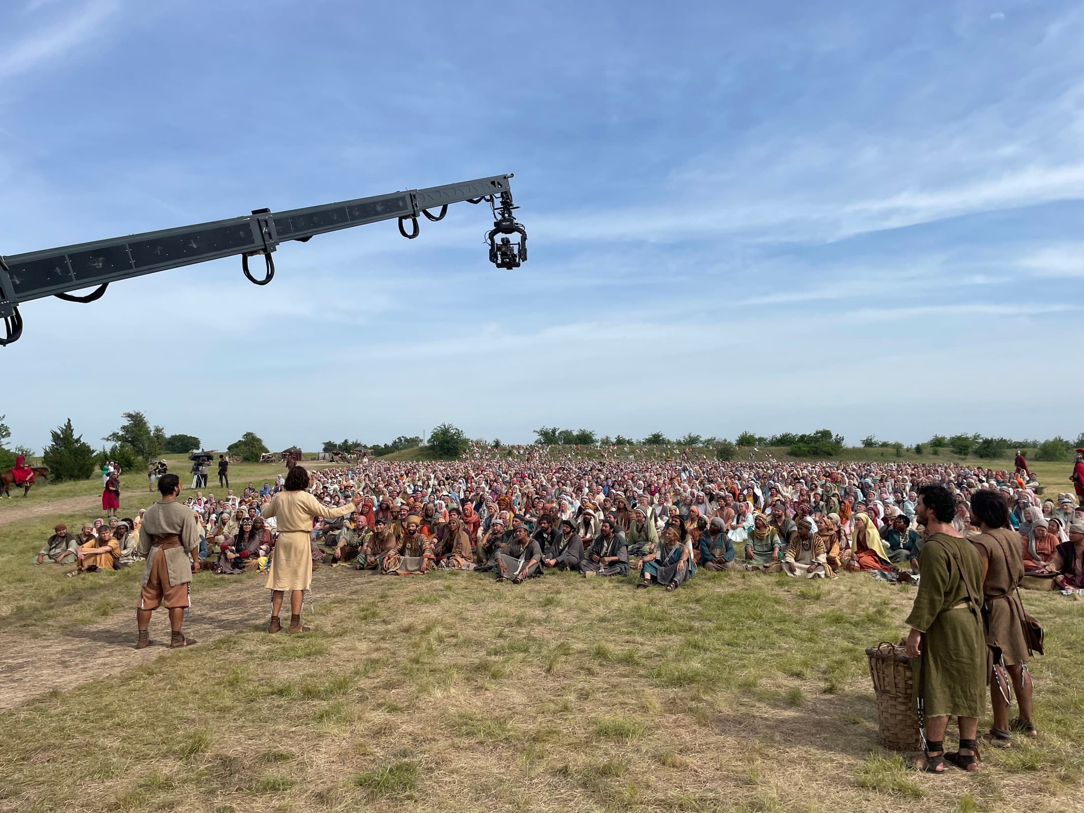 A large period production filming an exterior crowd scene